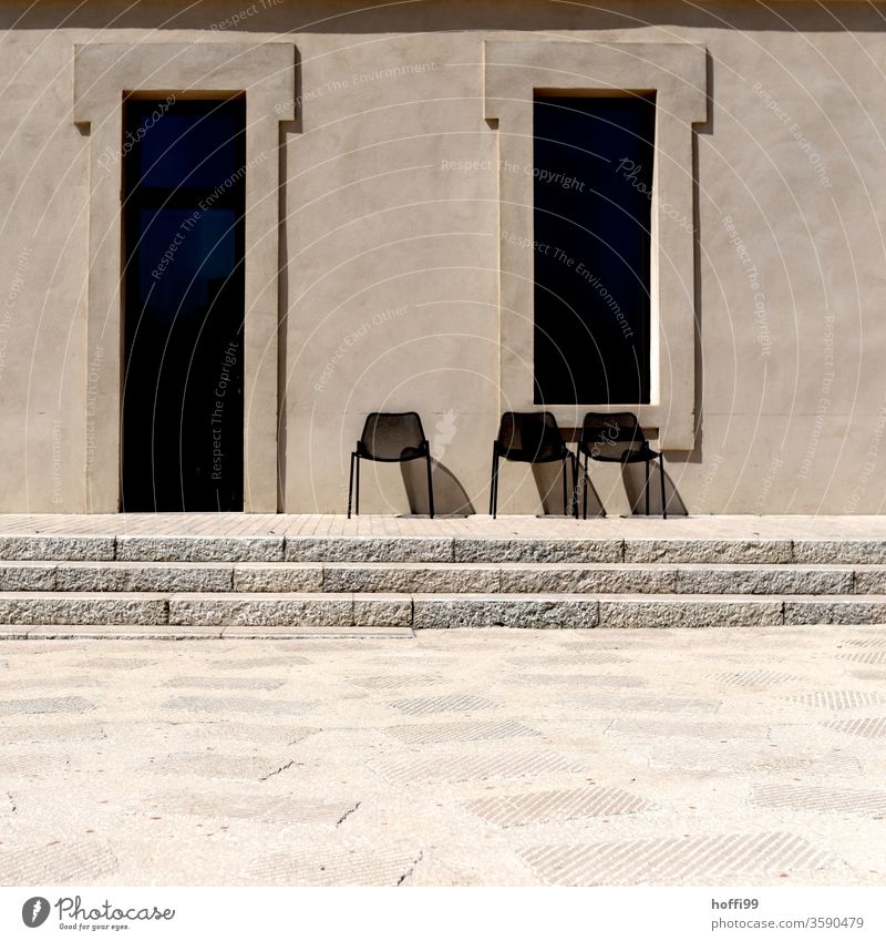 Three chairs in the sun are waiting for guests three Chair Group of chairs Row of chairs sandstone wall Wall (building) Sandstone Facade Stone wall Arrangement