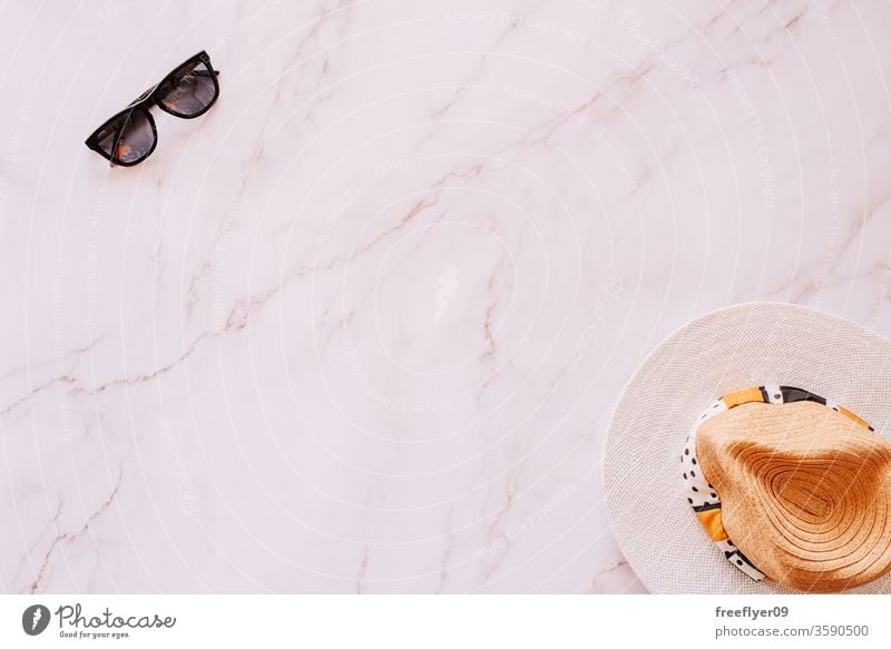 Flat lay of objects related to summer, spring and leisure against a marble background sunglasses hat flat lay flatlay copy space copyspace still still life