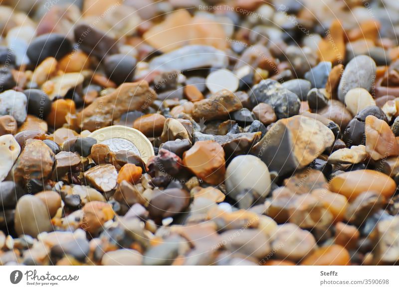 not searched and yet found stones Money coin Coin Treasure variety colorful mixture Search covert Discovery Hiding place Pebble beach treasure hunt