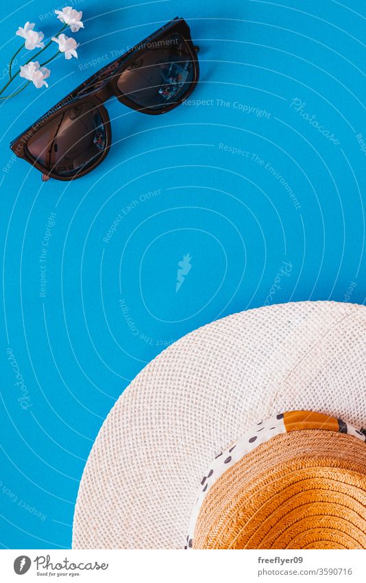 Flat lay of objects related to summer and spring against a blue background sunglasses hat flat lay flatlay copy space copyspace still still life from above