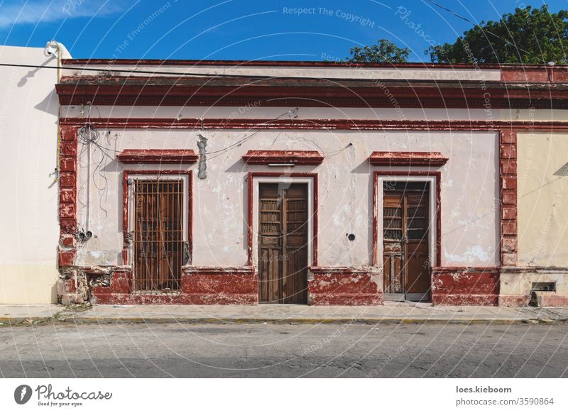 Facade of typical Mexican colonial building with wooden doors in Merida, Yucatan, Mexico mexico facade tourism yucatan merida street mexican colorful