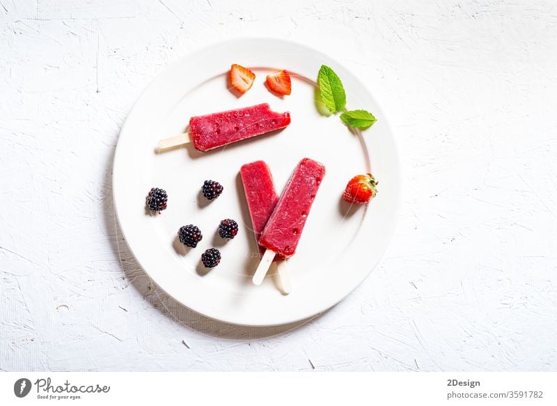 Delicious strawberry popsicles on white background ice cream pole dessert food sweet cold mint glace stick fresh healthy snack top cool dish eat blackberry