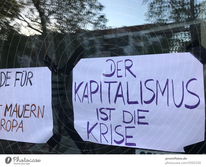 Window display: "Capitalism is the crisis". Photo: Alexander Hauk neoliberalism protest Democracy Freedom of expression reflection daylight Exterior shot corona