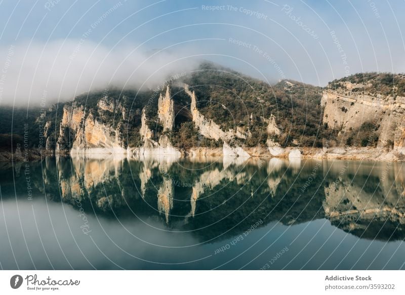 Calm lake among foggy rocky mountains landscape cold nature reflection rough range spain montsec magnificent calm water surface mirror tranquil scenic
