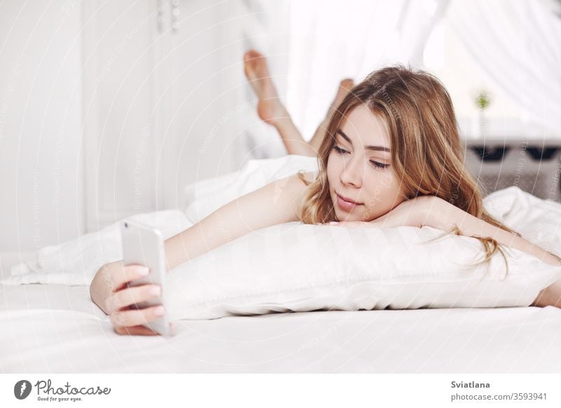 A Beautiful Young Girl In Blue Pajamas Is Sleeping On A Bed In Her Bright Bedroom At Home In The Morning A Royalty Free Stock Photo From Photocase