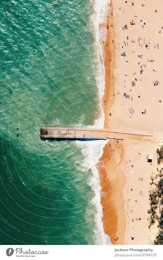 Aerial view of pier and beach in Albufeira, Portugal portugal albufeira aerial copy space landscape people tourists touristic algarve atlantic sunny yellow