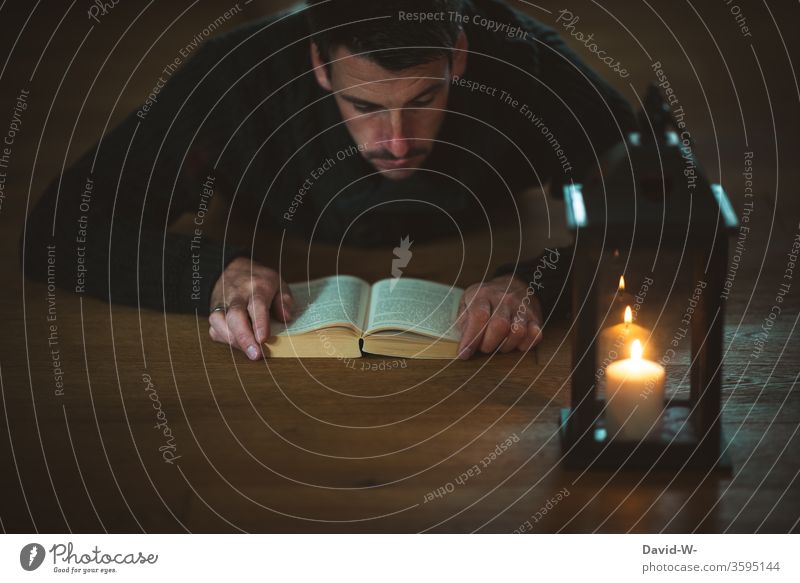 read an exciting book by candlelight Reading Book Candlelight shoulder stand Lantern Man Reader Ground Literature Education Academic studies Novel Tension