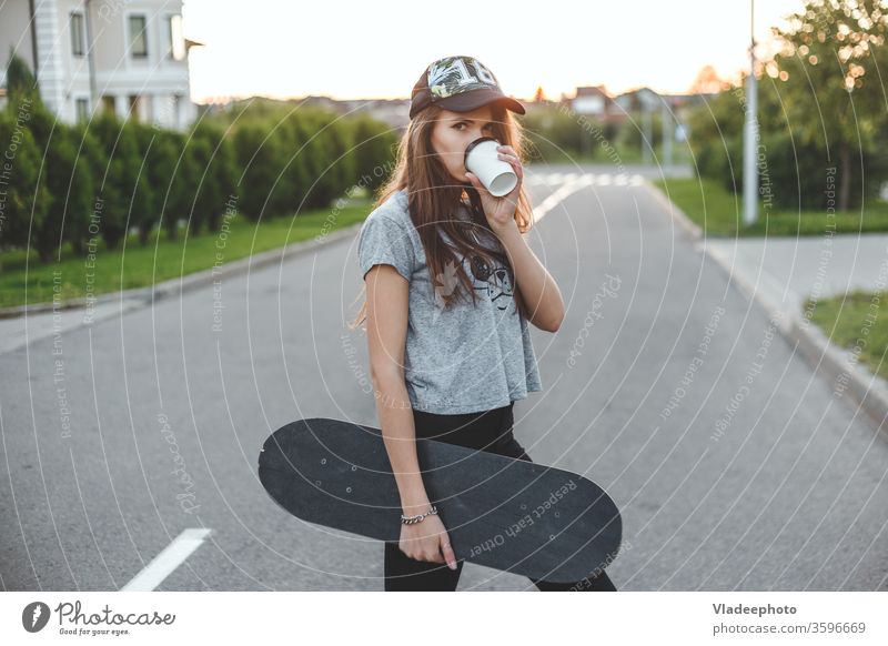 The girl with an active lifestyle starts with morning coffee and skating. Cup Coffee Drinking Woman Street Style Fashion youthful Easygoing already Outdoors