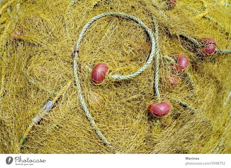 https://www.photocase.com/photos/3598752-yellow-net-for-fishing-with-rope-and-red-benefits-photocase-stock-photo-large.jpeg