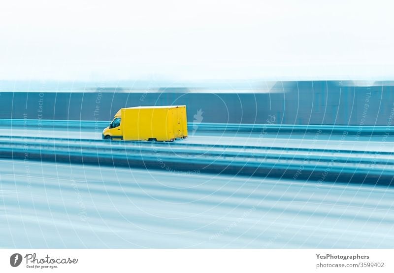 Delivery truck on the highway. Yellow van in motion asphalt automobile blank business car cargo copy space courier delivery driving empty fast freeway freight