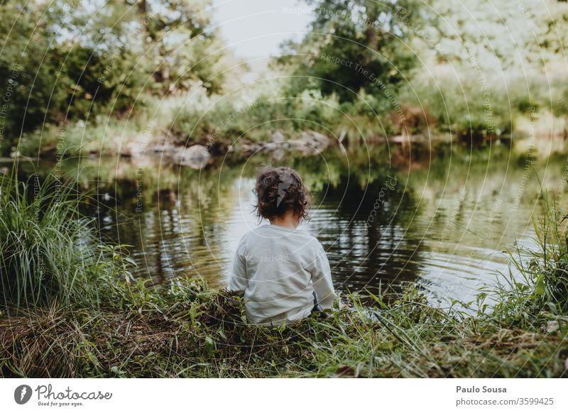 Little girl sitting by the river Child Rear view back view Caucasian 1 - 3 years River Human being Colour photo Infancy Exterior shot 3 - 8 years Toddler Day