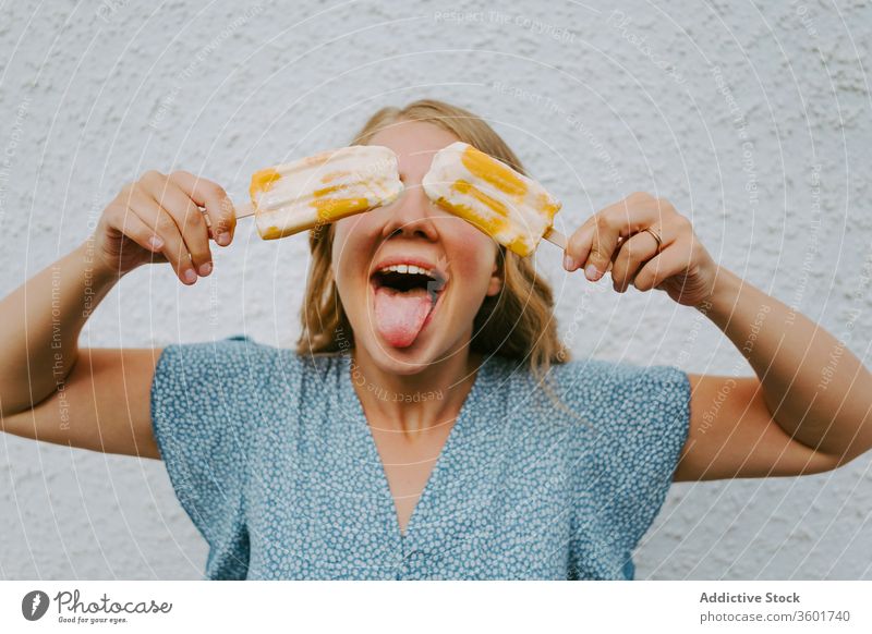 Happy woman with popsicles on white background grimace funny make face ice cream having fun lolly tasty female cheerful happy joy delicious stick playful