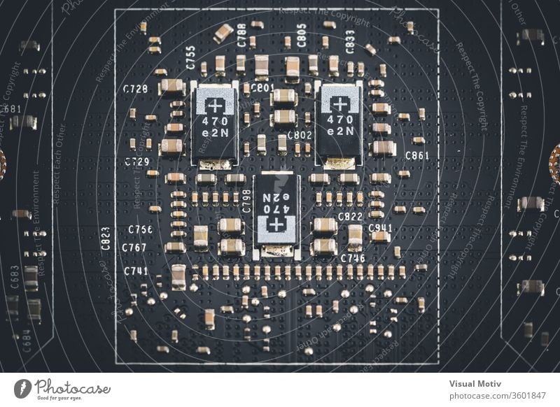 Macro view of electronic components of the printed circuit board of a graphics card macro microchip integrated circuit element metal metallic device