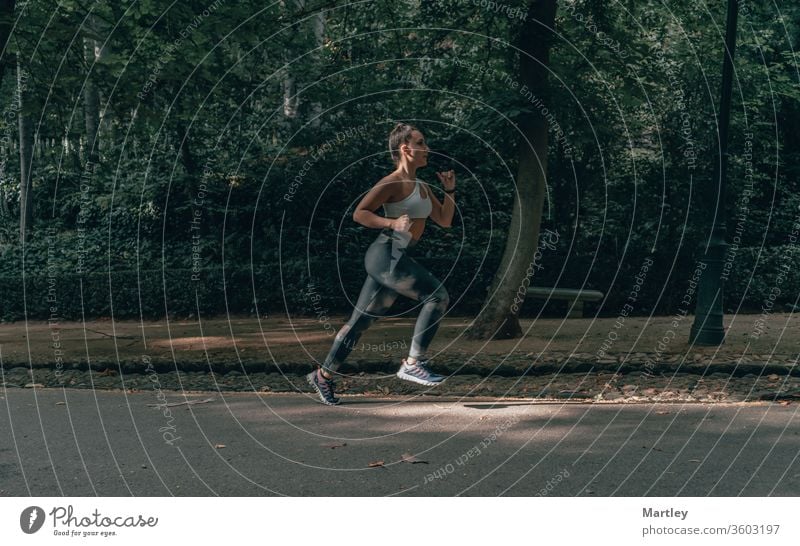Jogging Concepts. Portrait of Professional Female Runner During Outdoor  Training. Running on Track and Equipped in Summer Training Outfit While  Running. Stock Photo