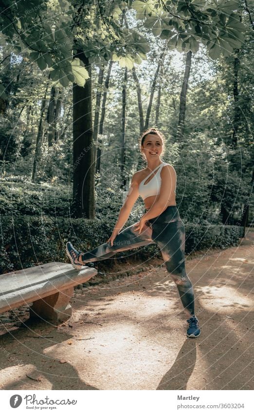 Young pretty sportswoman with leggings smiling and enjoying sports in a forest with fresh air in summer. nature smiling woman child young outdoors exercise