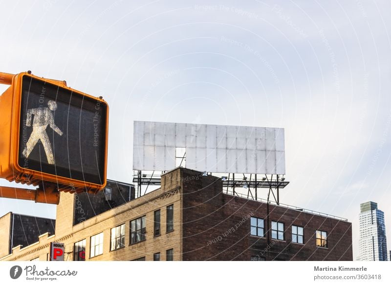 Pedestrian traffic light and empty billboard on a roof in New York City Architecture Way out on the outside office Window built Glass
