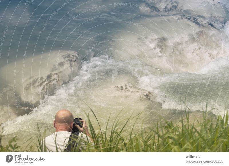 bald man takes pictures of rapids at the river Leisure and hobbies Take a photo Photography Photographer Man Adults Human being Nature Water Grass River bank