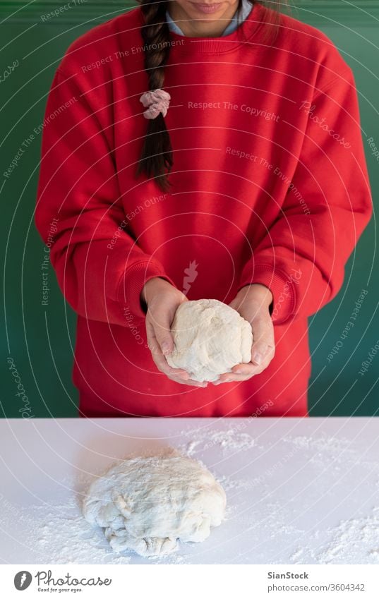 Woman prepares to her home handmade dough for bread, homemade cooking. woman hands white person powder pie pasta working bake-house food pizza female pastry raw