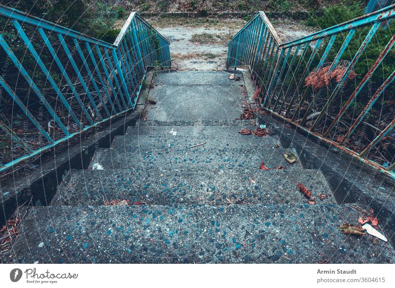 old concrete staircase with rusty blue railing abandoned ancient architecture background construction dirt down gray grunge handrail iron life metal nature