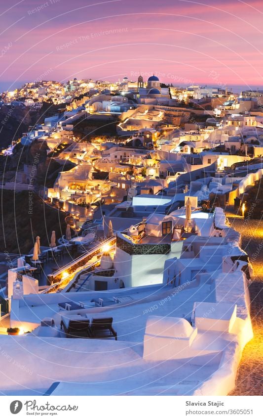 Unique view for the sunset over Oia, Santorini, a small, beautiful village on the edge of the caldera, Greece aegean architecture blue building church city