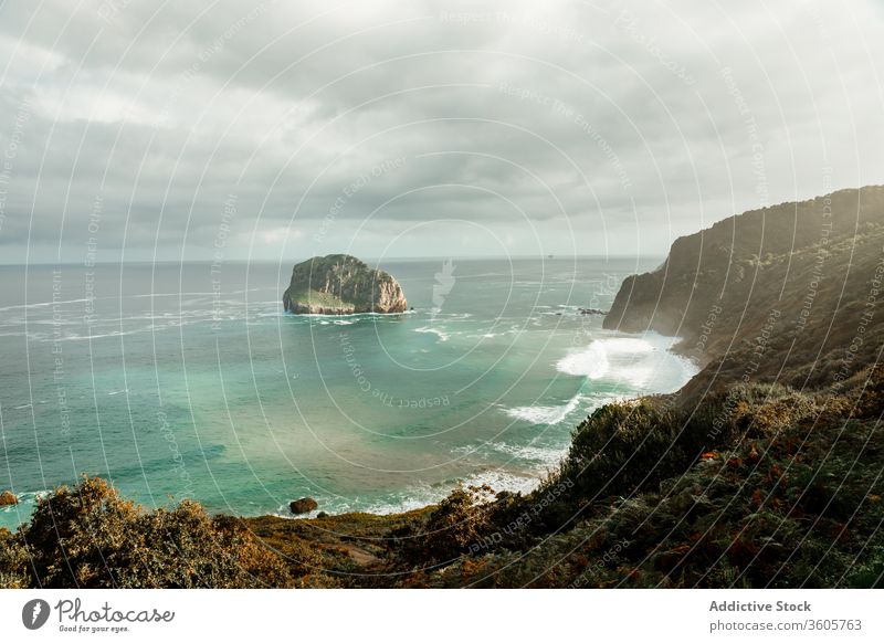 Hill with grass near sea under cloudy sky hill wave seascape breathtaking picturesque foam harmony nature paradise skyline peaceful spectacular horizon idyllic