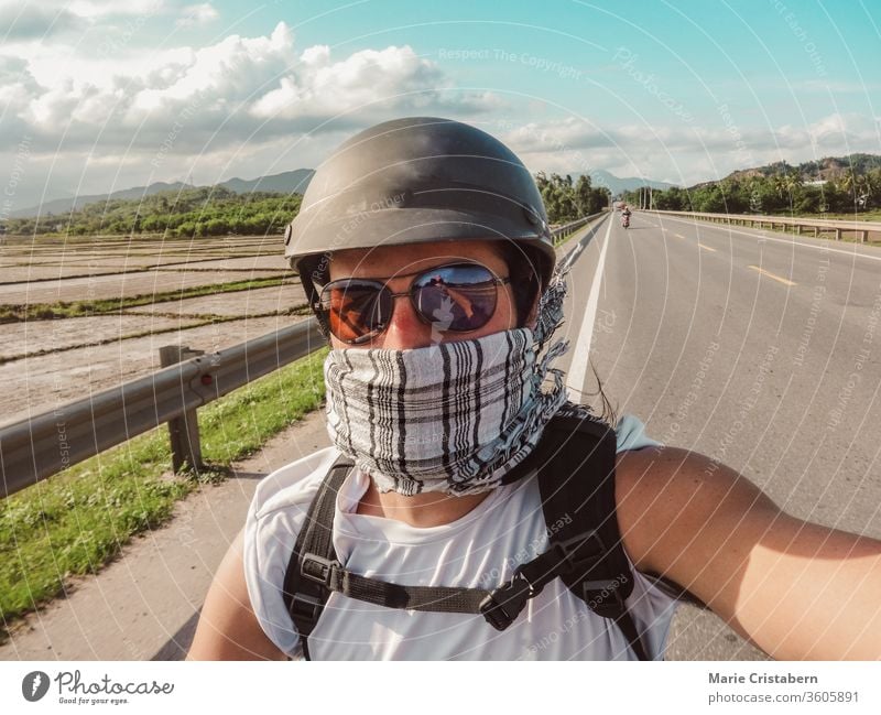 A tourist stops for a selfie during a motorcycle tour in Vietnam Car journey Motorcycle Trip Tourist Tourism voyager Wanderlust Adventure Selfie