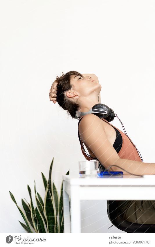 Young tired freelancer woman stretching at home workplace 1 female business person people sitting office young relax desk girl lifestyle working happy white