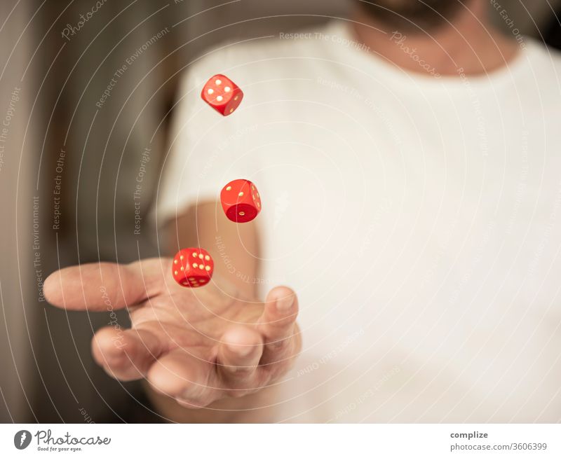 Man throws dice in the air luck Playing Poker Table Success Financial Industry Stock market Adults by hand wood Digits and numbers Throw Hope Dangerous