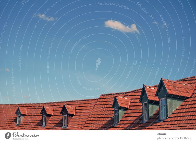 six dormer windows in a row on a tiled roof with blue sky and small fair weather clouds Skylight Window Tiled roof decorative cloud Dormer Roofing tile Exposure