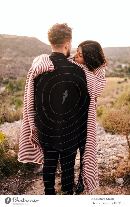 Gentle couple embracing on hill during vacation hug valley admire mountain together spectacular scenery girlfriend boyfriend plaid relationship nature love