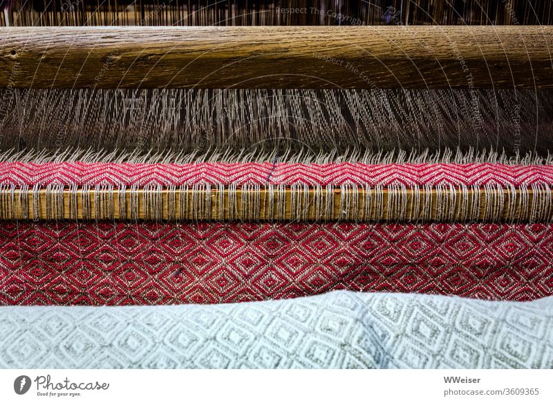 A cloth is made in a loom Loom Weaving Rag Cloth threads Craft (trade) textile Pattern colors Folklore Material weave Handcrafts hand woven traditionally