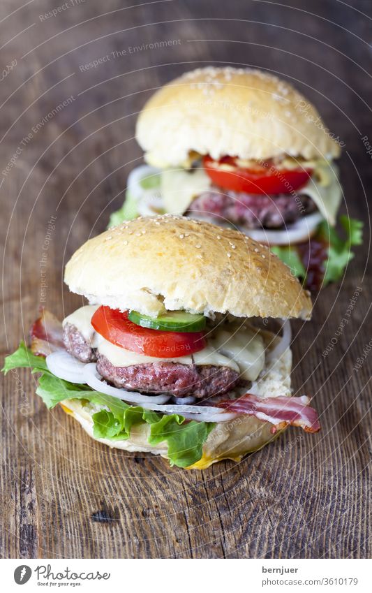 homemade hamburgers on rustic wood Hamburger Juicy two Beef Eating Cheese Lettuce background Meat Delicious American tomatoes White Onion Looking Meal sandwich