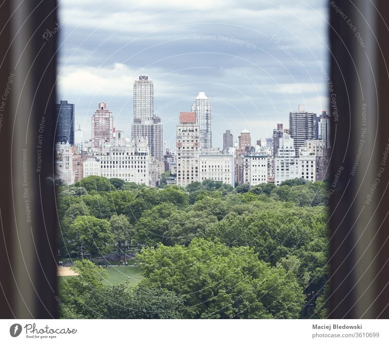 Central Park and Manhattan Upper East Side seen through a window, New York. City USA architecture urban toned filtered park building retro view sky cityscape