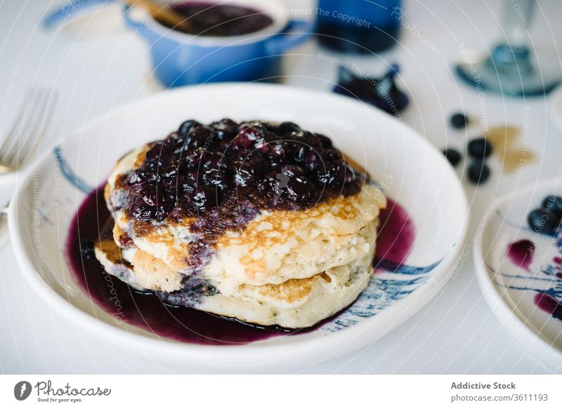 Pancakes with jam in table at home brunch breakfast pancake blueberry eat homemade food delicious portion cut morning tasty meal fresh sweet dish cuisine