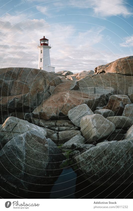 Lighthouse against cloudy sundown sky lighthouse sea shore sunset water peggys cove canada dusk twilight ocean coast nature weather idyllic scenic nobody rock