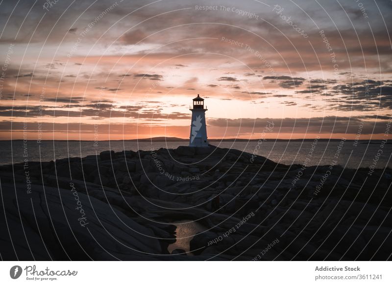 Lighthouse against cloudy sundown sky lighthouse sea shore sunset water evening peggys cove canada dusk twilight ocean coast nature weather idyllic scenic