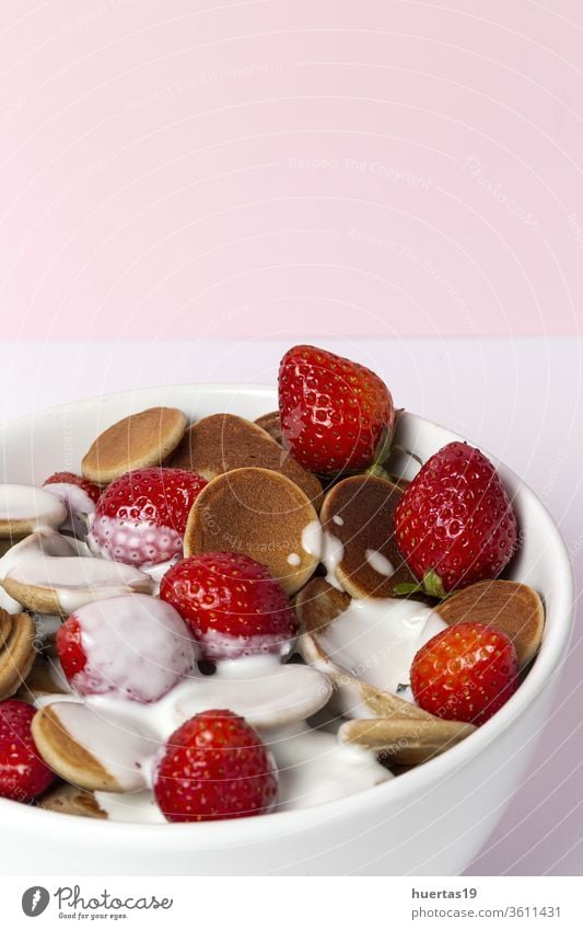 Homemade cereals mini pancake with yogurt, honey and strawberries on colorful background. homemade pankakes delicious food dessert vegan food healthy tasty