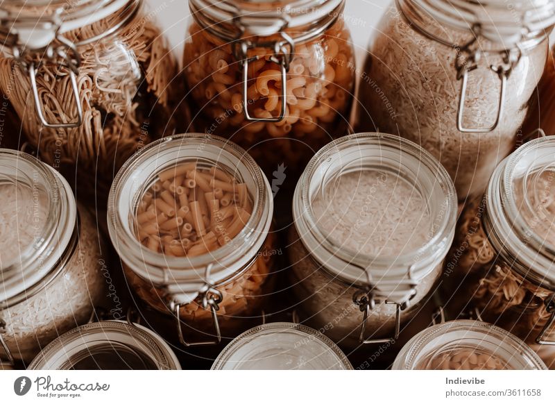 https://www.photocase.com/photos/3611658-air-tight-glass-jars-full-with-dried-uncooked-food-ingredients-pasta-noodle-rice-in-food-container-storage-dot-photocase-stock-photo-large.jpeg