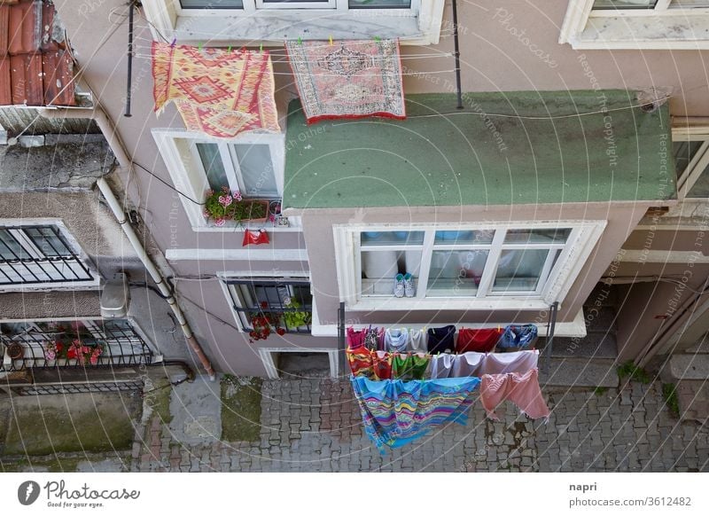 Drying time | laundry hangs to dry on clotheslines outside the windows of a house in a narrow alley of Istanbul. from on high Clothesline Household Alley
