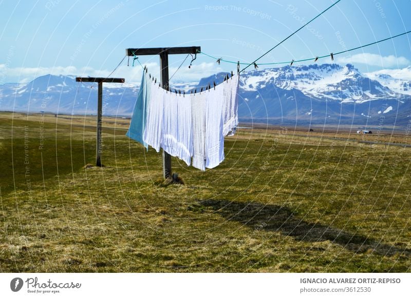 Laundry hanging clothes and towels outdoors with a great background - a  Royalty Free Stock Photo from Photocase