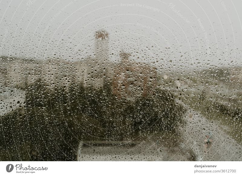 Rain drops on a transparent glass. Evening view of a city traffic. - a  Royalty Free Stock Photo from Photocase