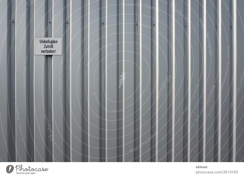 "No Trespassing" sign on a gray metal facade No admittance metal gate Facade Gray Working environment unauthorized interdiction Stripe Admission Closed