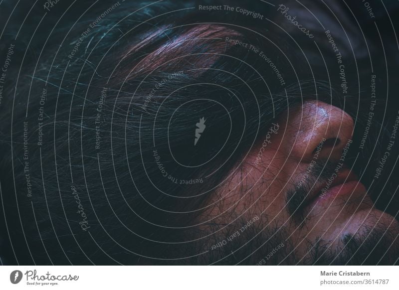 Conceptual photo of a man blindfolded by human hair showing concept of struggle, mental health illness and it's social stigma creepy world mental health day