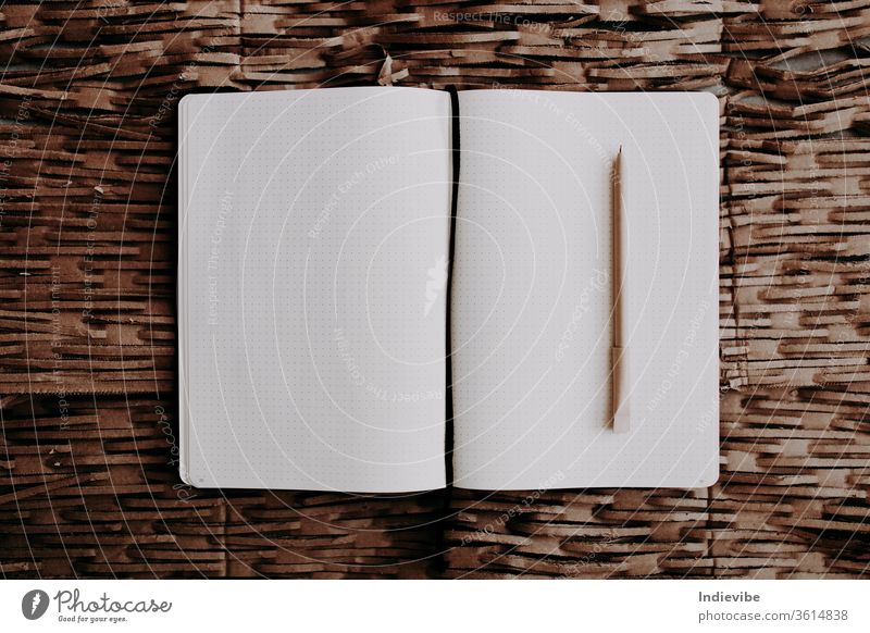 An open book with a pen on a recycled cardboard background blank box bright business concept dark decrease diary dot double eco eco friendly empty flat lay free