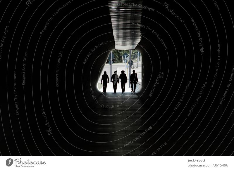 four figures enter, into the great darkness Tunnel Back-light Silhouette Lanes & trails Passage Dark Pedestrian Low-key Tunnel vision Going Symmetry