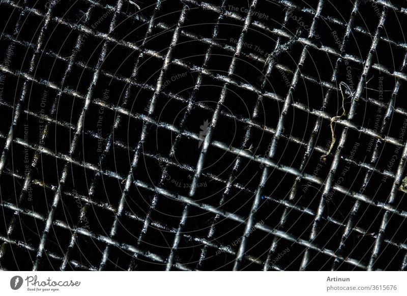 Dirty grille for filter and collect used motor oil in car or motorcycle. Black oil  or automotive fluids stains on grille. Recycling used motor oil reused as fuel oil for help environment. Carcinogens