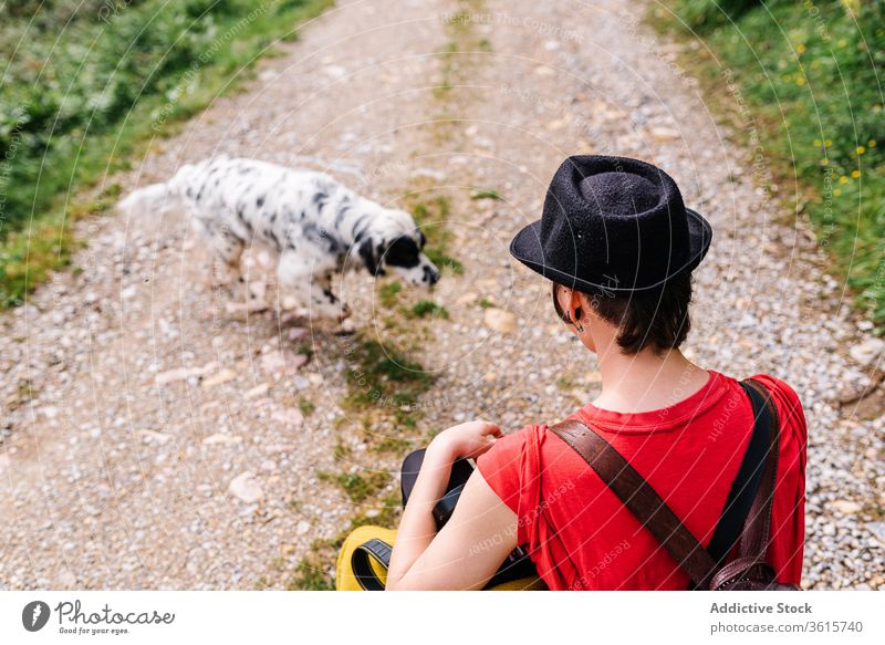 Informal female photographer with dog on rural road countryside woman photo camera english setter informal style asturias spain photography pet nature backpack
