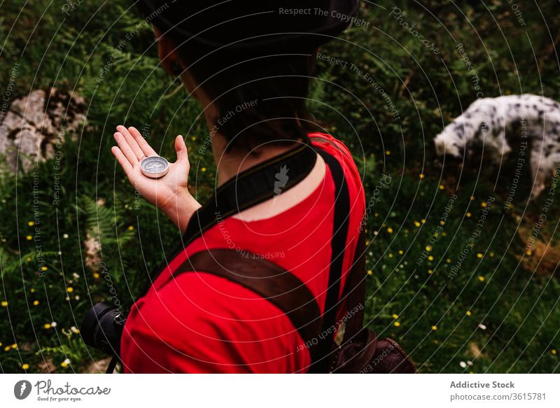 Unrecognizable female tourist navigating by compass navigate traveler woman orientate holiday meadow find backpack asturias spain style photo camera wanderlust