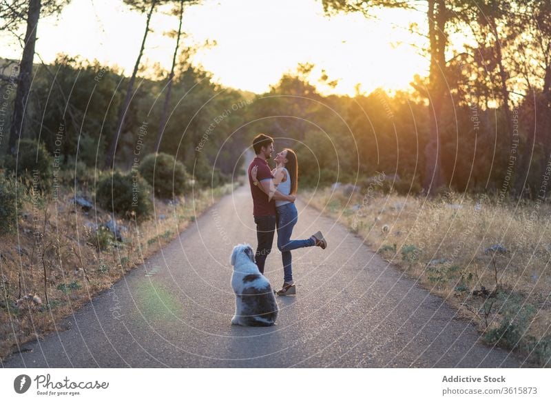 Tranquil happy couple on road with dog tranquil sunset harmony together unity relax stand amazing girlfriend boyfriend roadway old english sheepdog enjoy