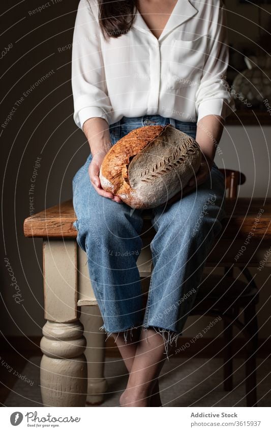 Crop woman with fresh bread delicious baked kitchen bakery table loaf nutrition female homemade pastry food tradition sit wooden meal tasty gourmet lady healthy